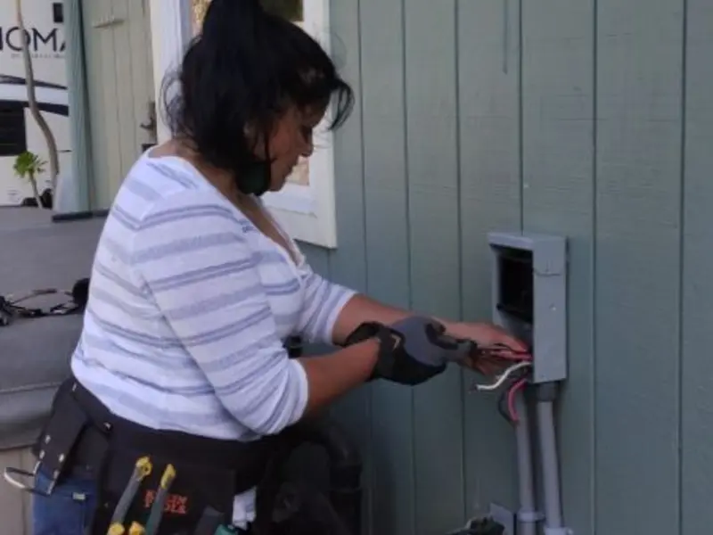 Licensed electrician wiring an exterior subpanel in Feather Sound